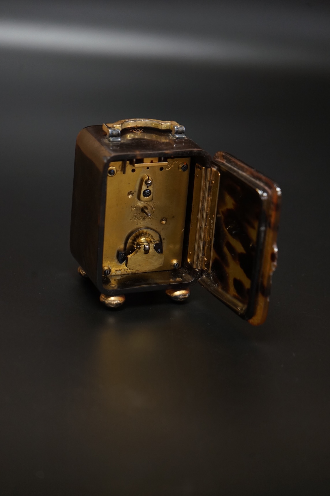 An Edwardian silver gilt mounted tortoiseshell carriage timepiece, with Roman dial, H.A. & Co, London, 1909, 87mm excluding the handle (a.f.)